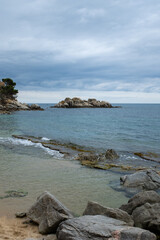 Beautiful sandy beach in quiet waters of Mediterranean Sea in Costa Brava