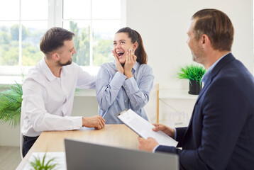 Happy couple of clients celebrates the signing of a contract with a financial adviser or real estate consultant. Agreement marks a significant milestone in insurance or property investment journey.