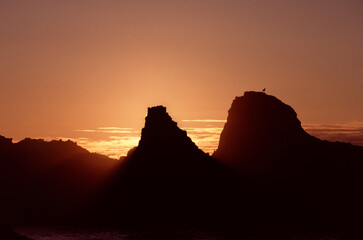 Sunset on the rocks by the sea