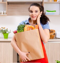 Young woman with vegetables in the kitchen