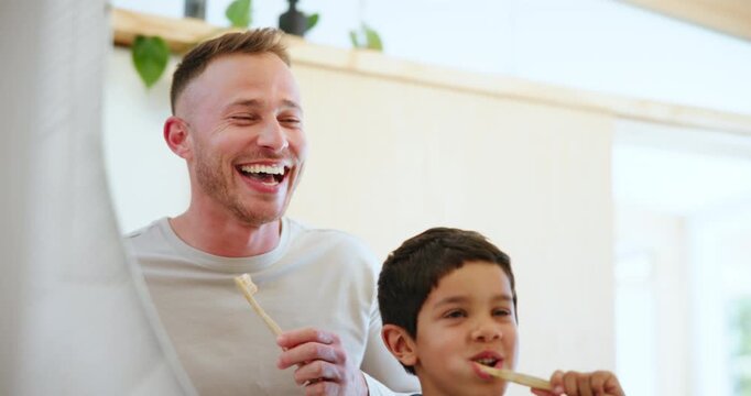 Father, kid and brushing teeth in mirror and morning routine playful in bathroom, hygiene and wellness. Dental care, oral health and toothbrush with toothpaste for teaching, cleaning and family