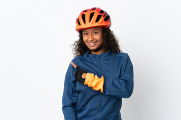 Teenager cyclist woman isolated on white background pointing to the side to present a product