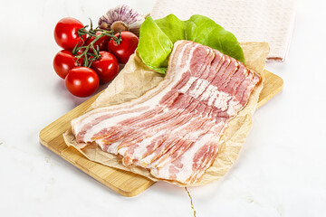 Sliced pork bacon oved board