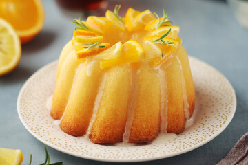 A sweet citrus cake served with oranges and lemons