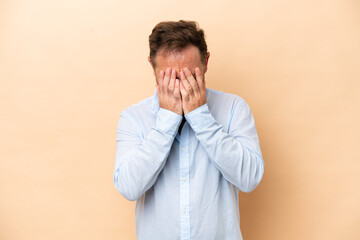 Middle age caucasian man isolated on beige background with tired and sick expression