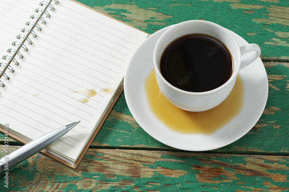 Wall mural Spilled coffee and a blank sheet of notepad