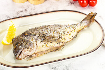 Baked Dorado fish served lemon