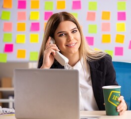 Young beautiful businesslady in conflicting priorities concept