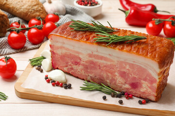 Piece of raw bacon with spices and cherry tomatoes on white wooden table