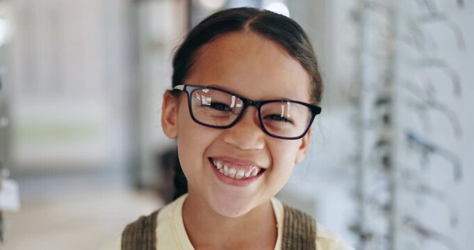Happy girl, kid and glasses for eyewear by shopping in optometrist office for corrective, lens and frame. Young person, excited and emoji with smile for choice with spectacles, eye care and health