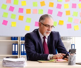 Aged man employee in conflicting priorities concept