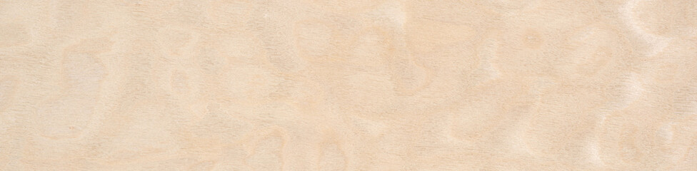 Soft sandy hues dance on the creamy veneer wooden surface in a delicate pattern