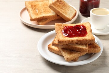 Delicious toasted bread slices with jam served on wooden table
