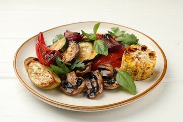Delicious grilled vegetables with spices on white wooden table
