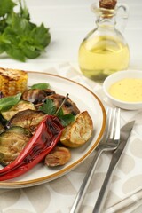 Delicious grilled vegetables with spices served on white table, closeup