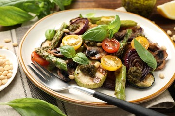 Delicious salad with grilled vegetables and fork on table, closeup