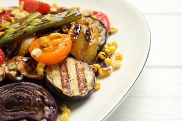 Delicious salad with grilled vegetables on white wooden table, closeup
