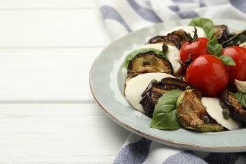 Tasty salad with grilled vegetables and mozzarella cheese on white wooden table, closeup. Space for text