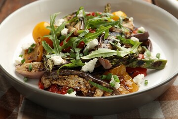 Tasty salad with grilled vegetables in bowl on table, closeup
