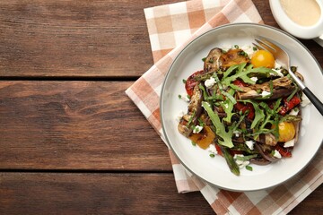Tasty salad with grilled vegetables served on wooden table, flat lay. Space for text