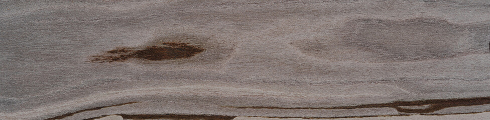 Fototapeta premium A serene landscape of walnut veneer, with undulating lines of deep espresso and smoky lavender, evokes natural tranquility