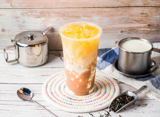 iced Taro Green Tea with Fresh Milk with sugar pot and spoon served in disposable glass isolated on table side view of hong kong tea