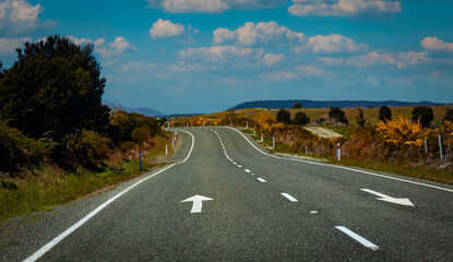 The road trip of journey on asphalt road among autumn forest and mountain