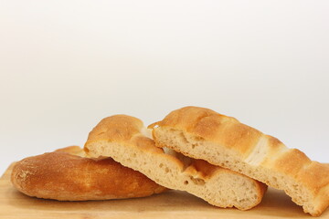 sliced  turkish pide bread (round flatbread) on wood