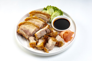Crispy pork belly in white plate isolated on white background