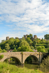 Dinham bridge over the River Teme with Ludlow castle behind in the town of Ludlow, Shropshire UK in Portrait orientation