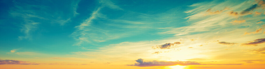 Sunset over the seashore with concrete embankment and small pier