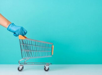 Minimalist Hand in Blue Medical Glove Pushing Shopping Cart with Face Mask on Light Pastel Background