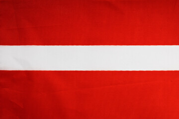 National flag of the state of Latvia close-up. State background.