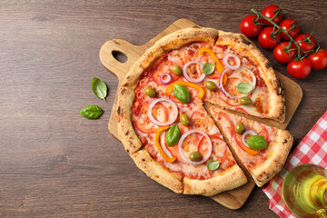 Delicious vegetarian pizza and tomatoes on wooden table, flat lay. Space for text