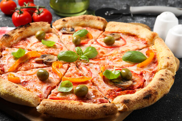 Cut delicious vegetarian pizza on grey table