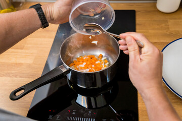 Chef at the kitchen preparing healthy quinoa bowl with avocado
