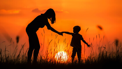 Obraz premium Mother and Child Silhouetted Against a Sunset
