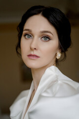 A portrait of a woman in white evening dress