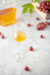 Grape vodka. Strong alcoholic drink in glasses on the table. Fresh grapes