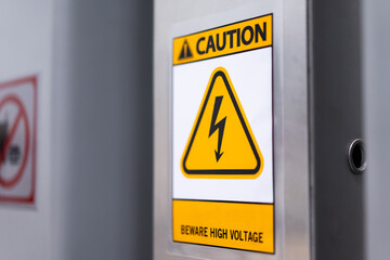 Caution sign: Beware of high voltage on the wall of the building, safety concept