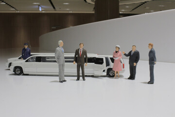 a figure of business man with limosineee car