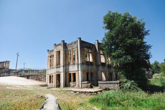Ruins of the historic Termas do Cró in Sabugal, Portugal. The abandoned spa structure, with its crumbling walls and overgrown surroundings, stands as a silent reminder of the past, blending history