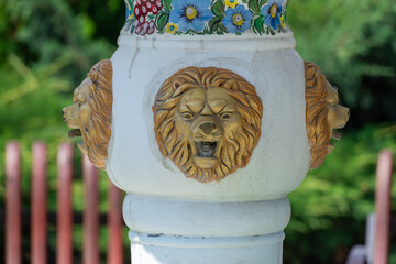 Design white fountain is head and mouth of lion. Painted pattern on falling water object in public...