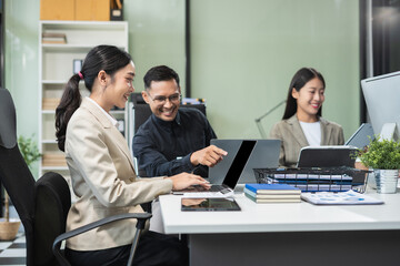 Business team working on a project in the office or reviewing and discussing a business project.