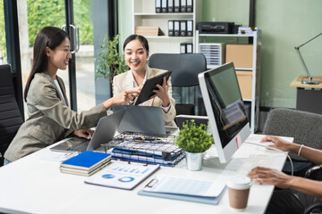 Business team working on a project in the office or reviewing and discussing a business project.
