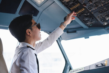 Successful serious airplane captain pilot preparing for flight at Airport. © NINENII