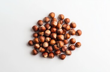 small pile of hazelnuts on a white background