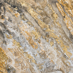 Creative texture on an artist canvas. Structure paste artwork with black, white and golden color. Gold foil used to design shimmering shapes. Abstract background image.