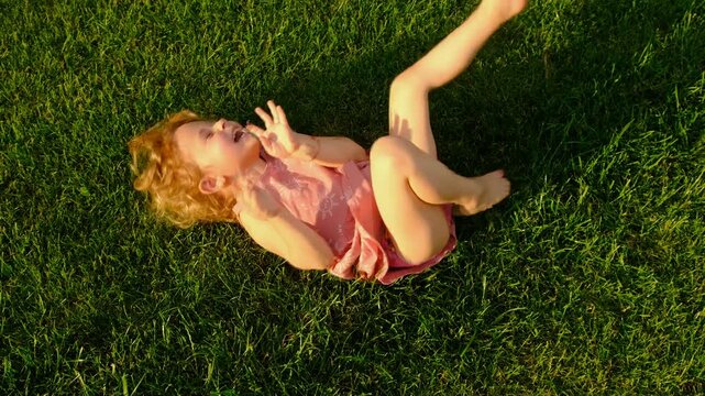 the child lies on the grass. Selective focus.