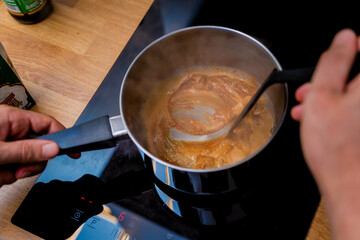 Chef at the kitchen preparing massaman curry with sweet potato and many spices